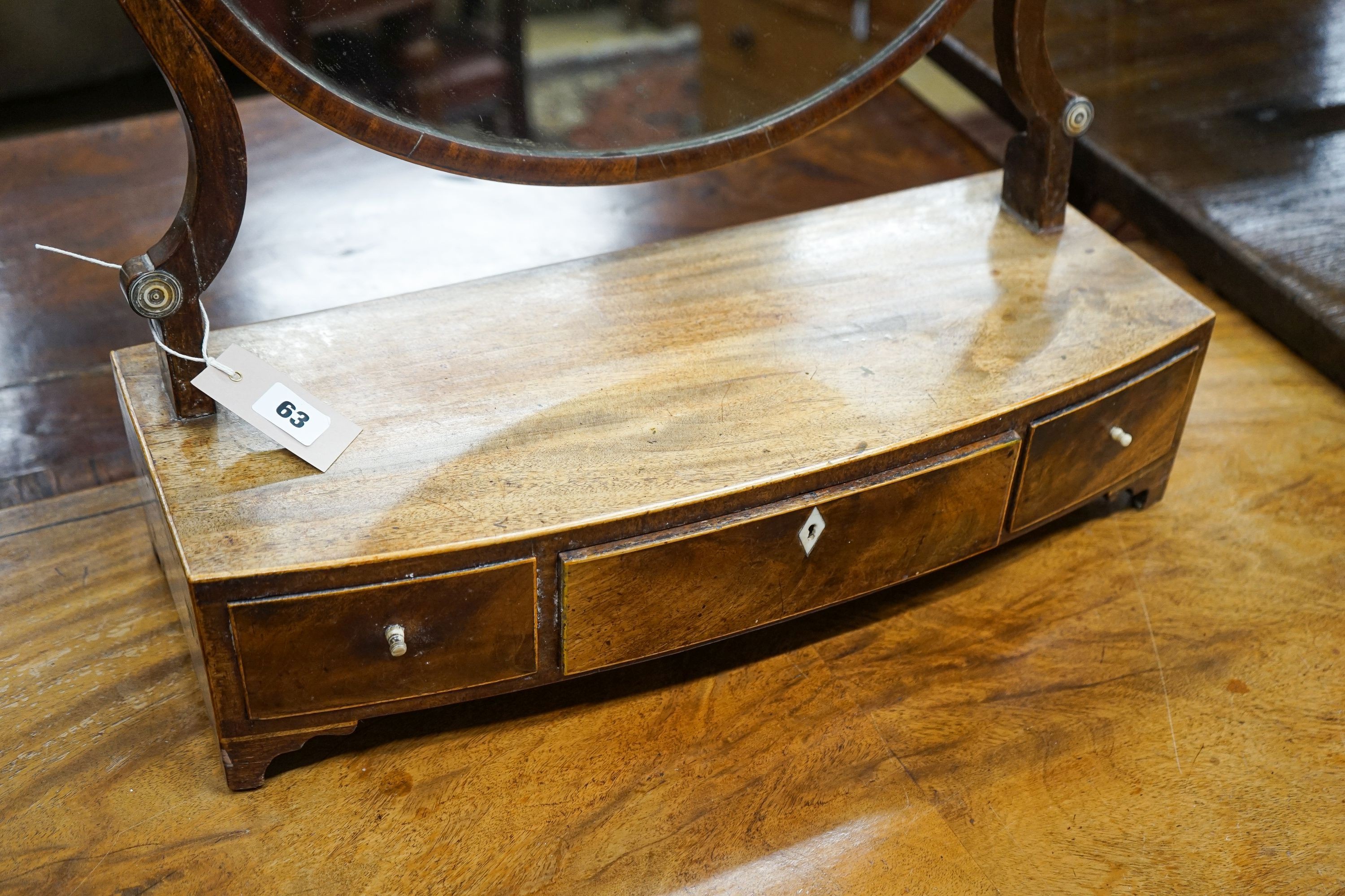 An early 19th century mahogany bowfront box base toilet mirror, width 54cm, depth 21cm, height 54cm